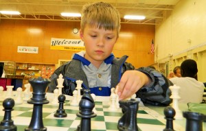Hillis student Henry Bissinger makes his move at the after school Monday Chess Club