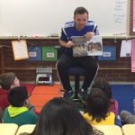 Ross Moffat from West Des Moines soccer club reading to a fourth grade classroom.
