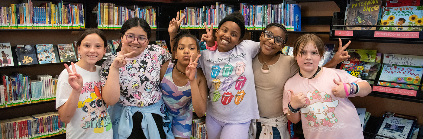 Students posing silly in library